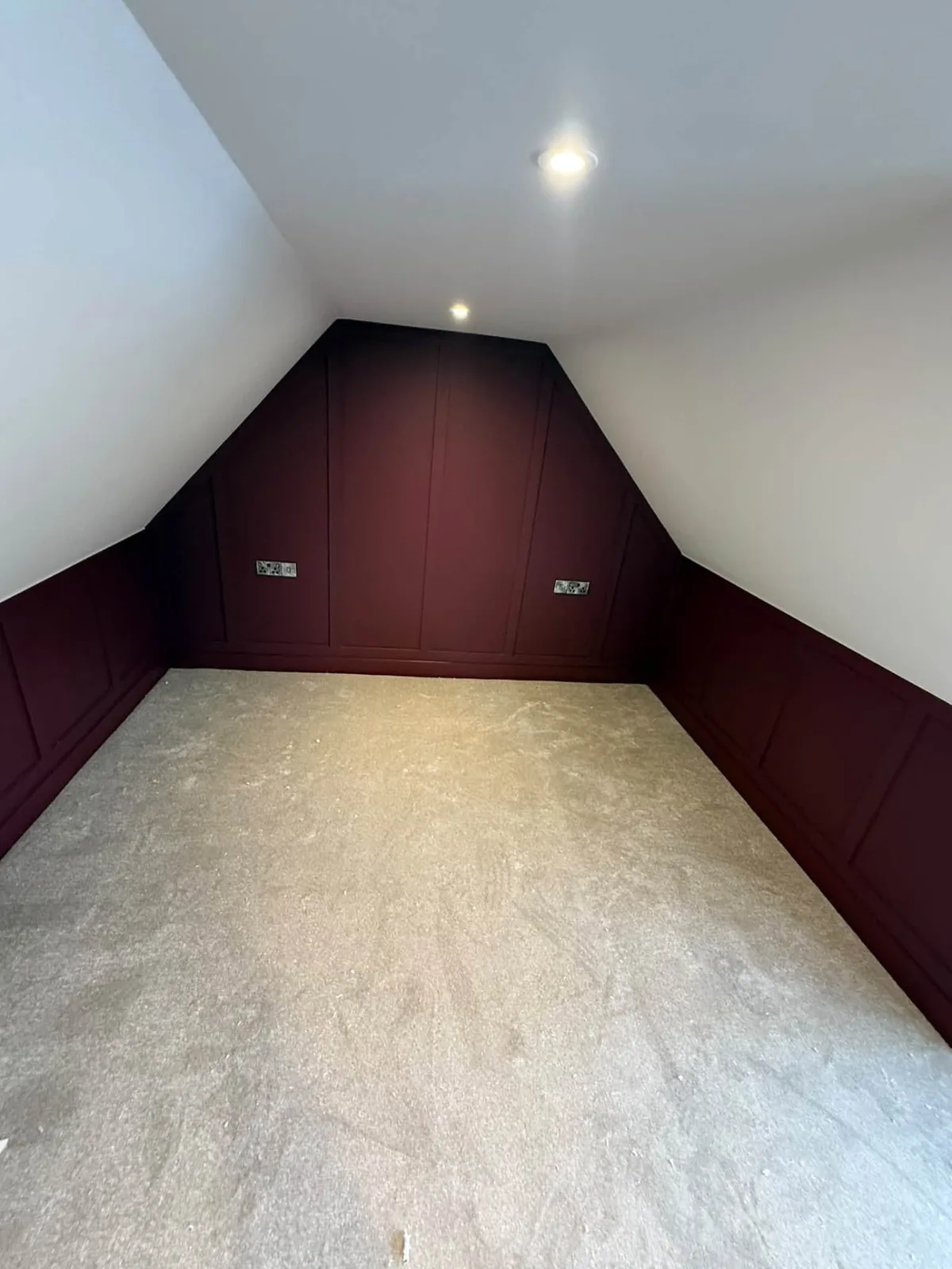Light beige carpet fitted in a loft room with panelled walls